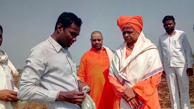 Mr. Mahesh with visitors on his farm.jpg