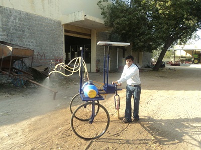 Mr Sangappa with his spraying machine 1.jpg